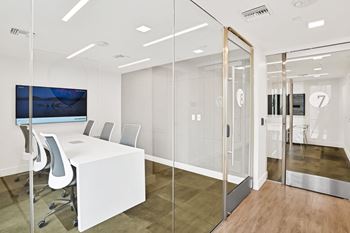 Fully equipped co-working lounge offering wifi, reservable meeting rooms, a coffee bar, and printer conveniences